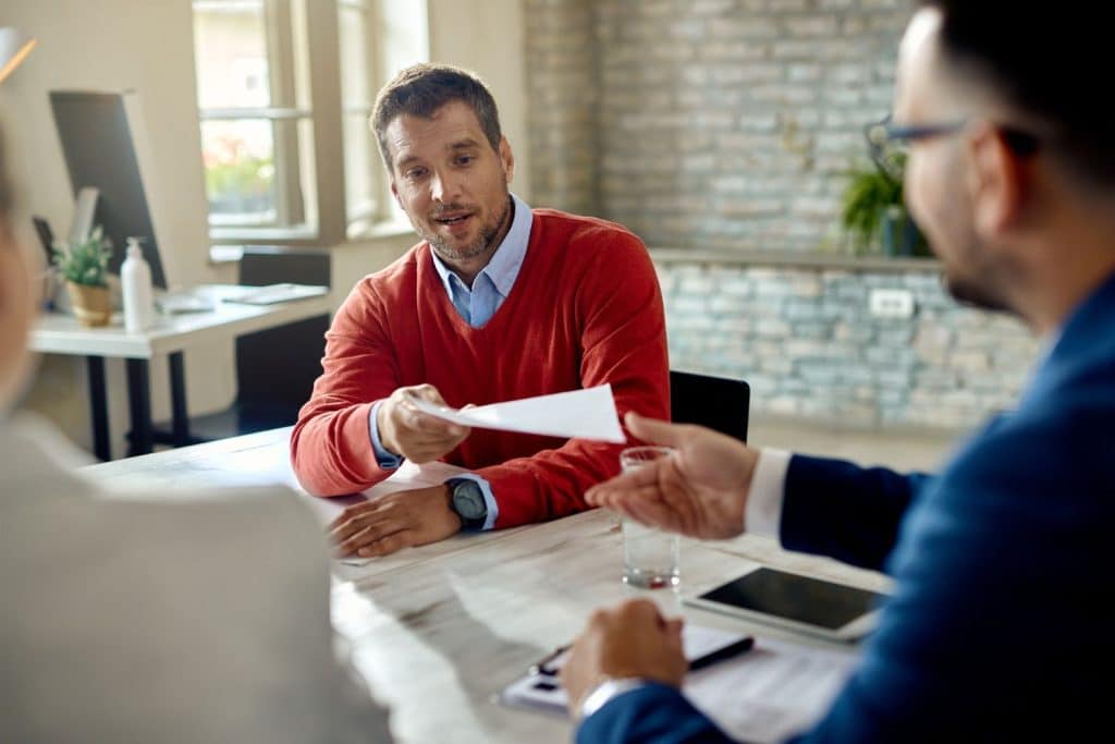 A borrower submits income verification and identification documents to complete a formal loan application.