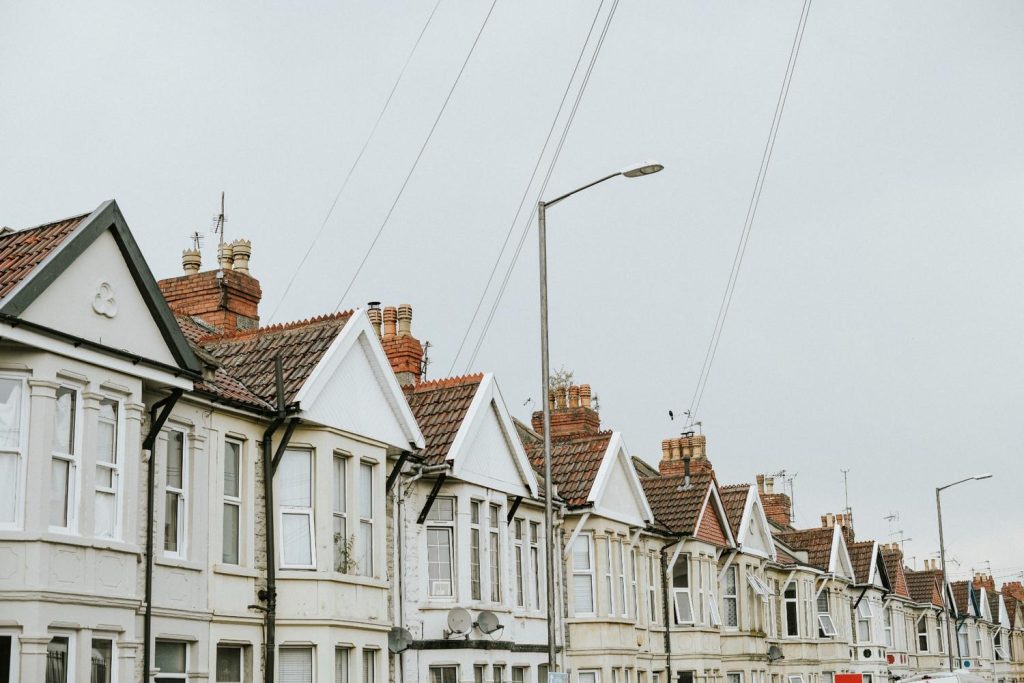 Row of Victorian houses illustrating how to find cheap homes in established suburban neighborhoods.