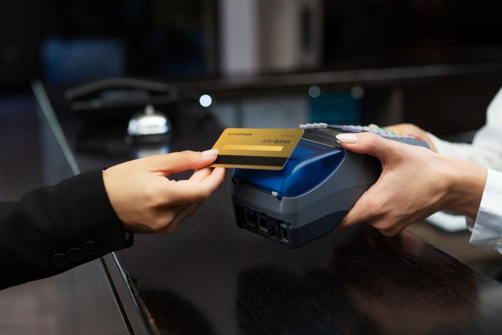 Person paying using a credit builder card