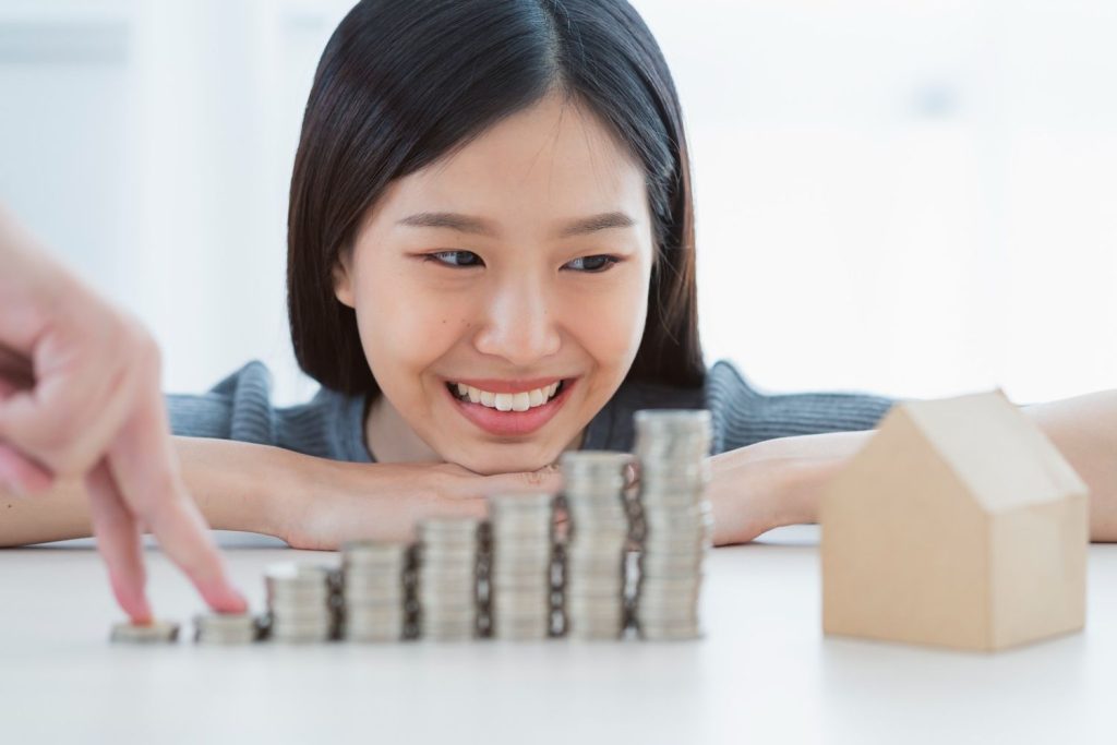 A happy woman watching her savings grow to secure a home equity line of credit for renovations.