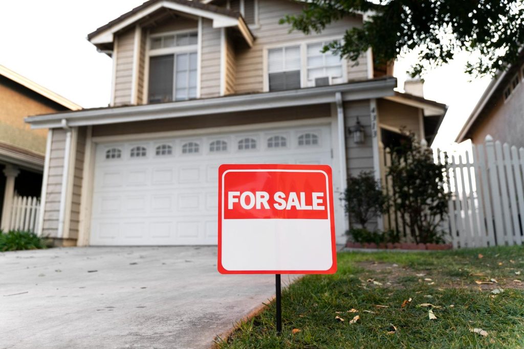 A suburban house for sale, representing a key step in how to buy a foreclosed home through local real estate listings.
