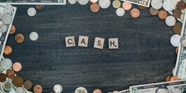 These are scrabble tiles that spell out the word "CASH."