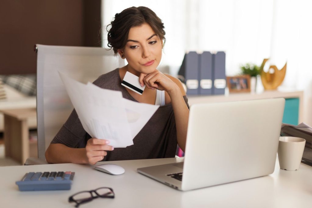 Woman looking her credit report for credit score recovery
