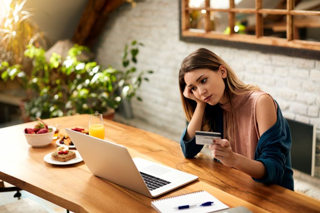 Woman feeling sad while checking her credit score and report