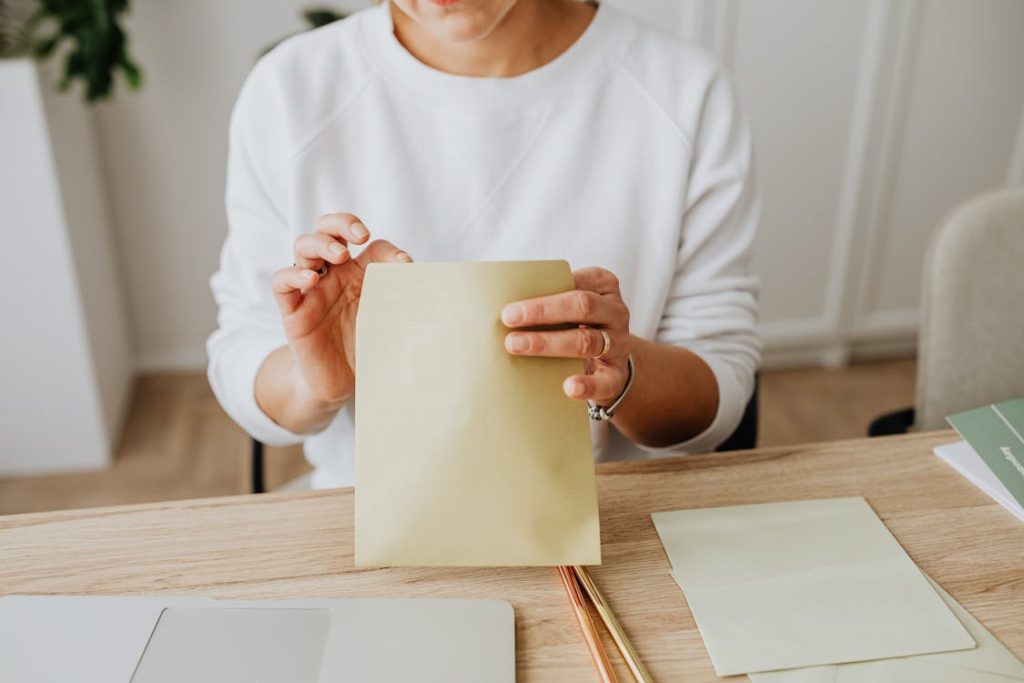Woman putting a debt settlement letter in an envelope