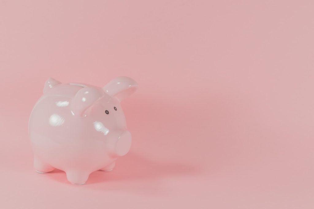 Pink piggybank in a pink background