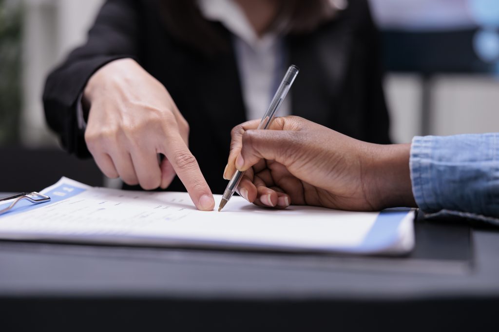 Woman signing agreed value insurance contract