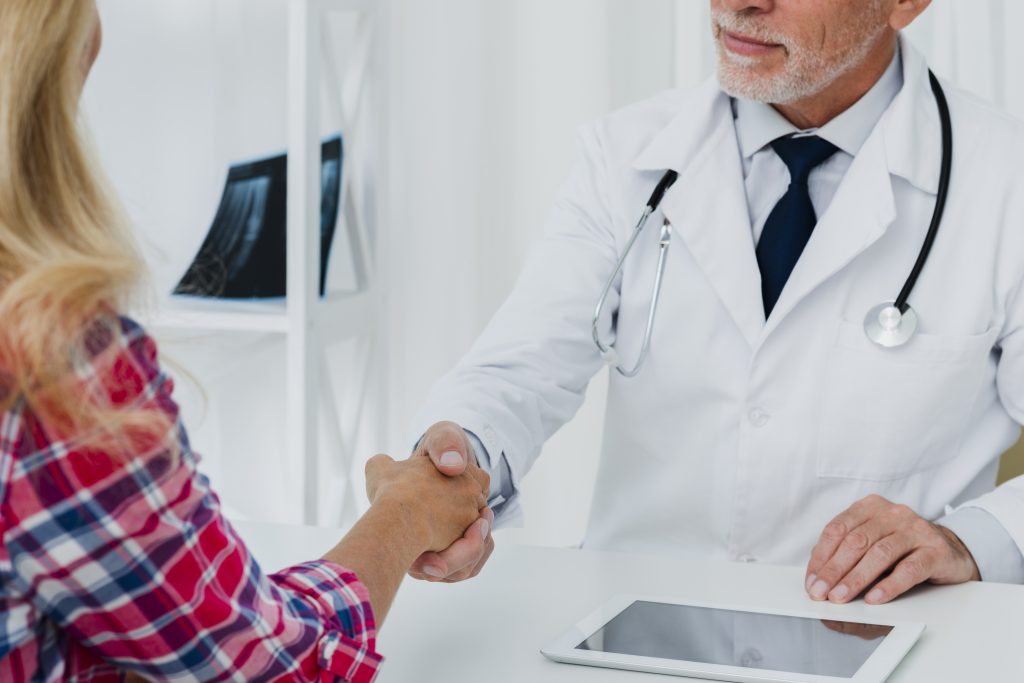 Doctor shaking a patient's hand after discussing coinsurance costs