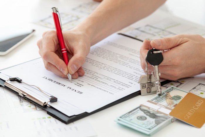 High angle man signing a rental agreement with flex rent payment