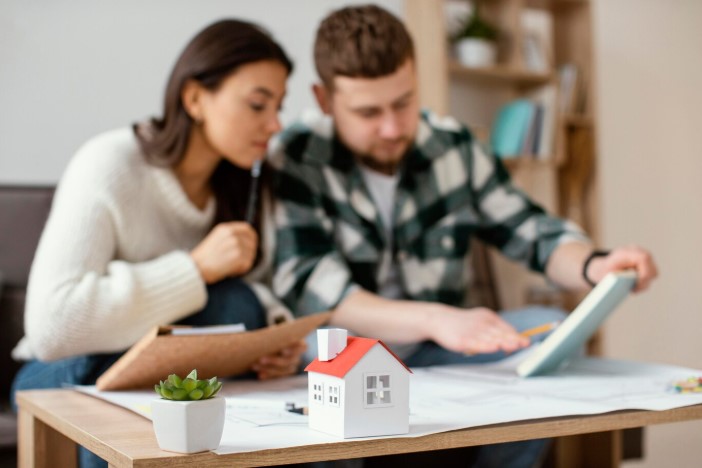 Couple looking at rental agreement papers with terms