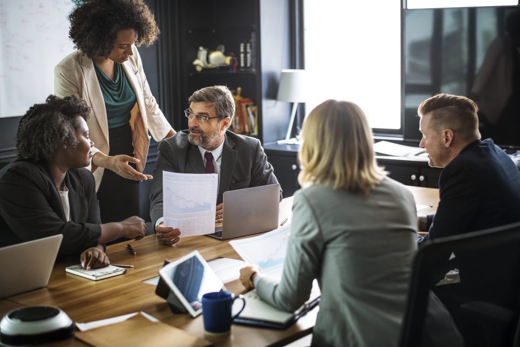 Business people in a meeting discussing ideas like a pure play approach