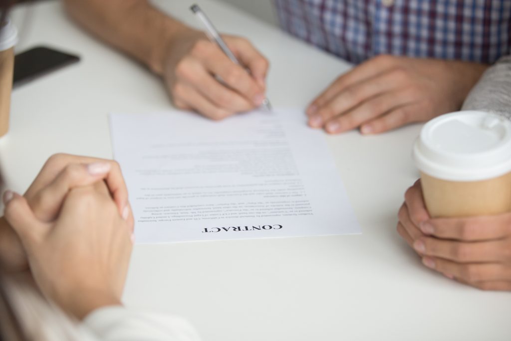 Man signing agreed value insurance contract