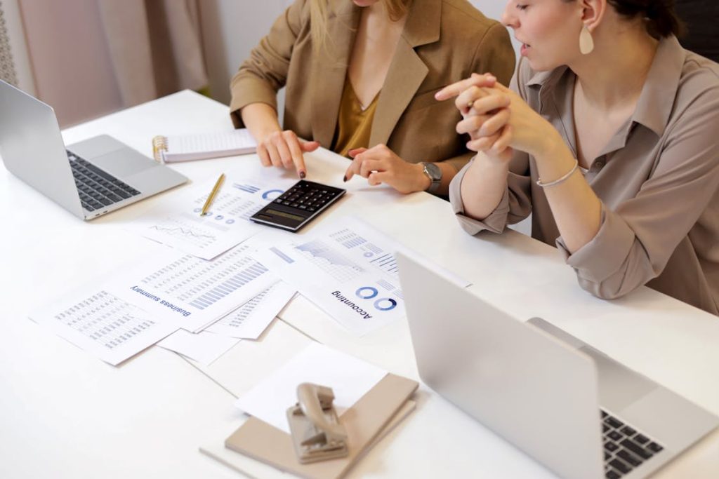 Women calculating tax-free investment accounts together 