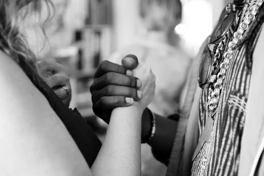 Grayscale photo of man and woman holding their hands for fiduciary bond