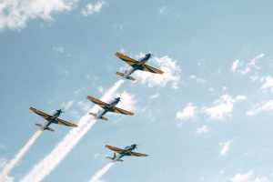 Four aircrafts flying representing Embraer