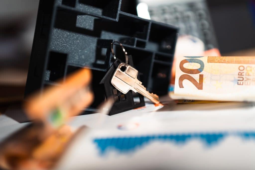 Keys and money on top of a table, types of real estate ownership
