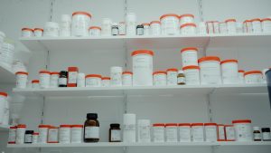 A shelf filled with white and orange medicine bottles representing Gilead news