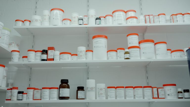 A shelf filled with white and orange medicine bottles representing Gilead news