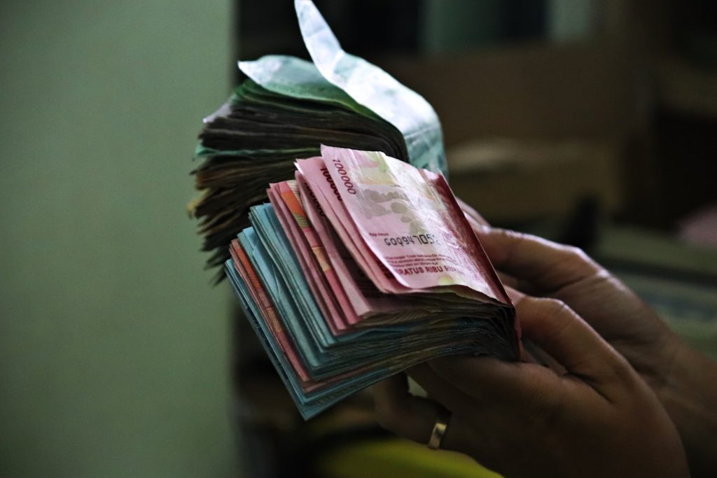 Hand holding paper bills for money scripts