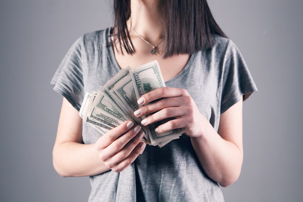 Woman holding paper bills for money scripts