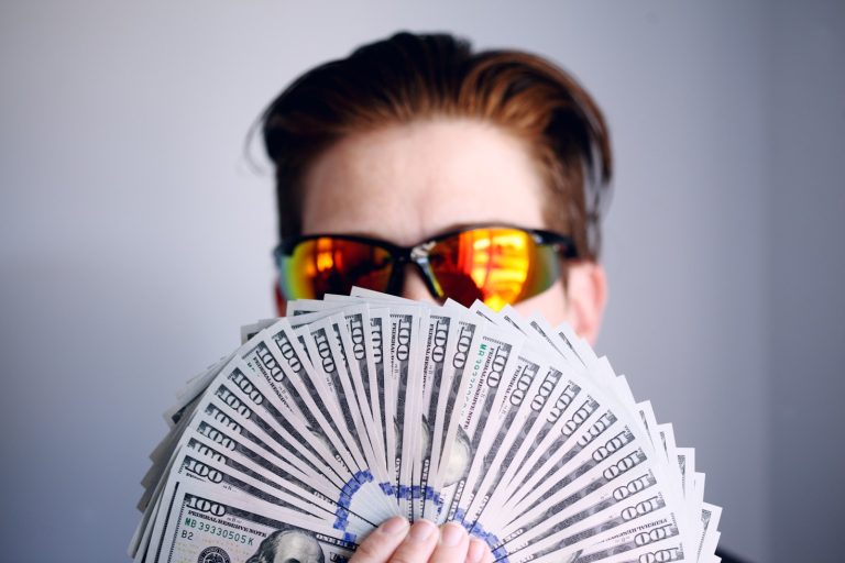 Person holding paper bills for money scripts