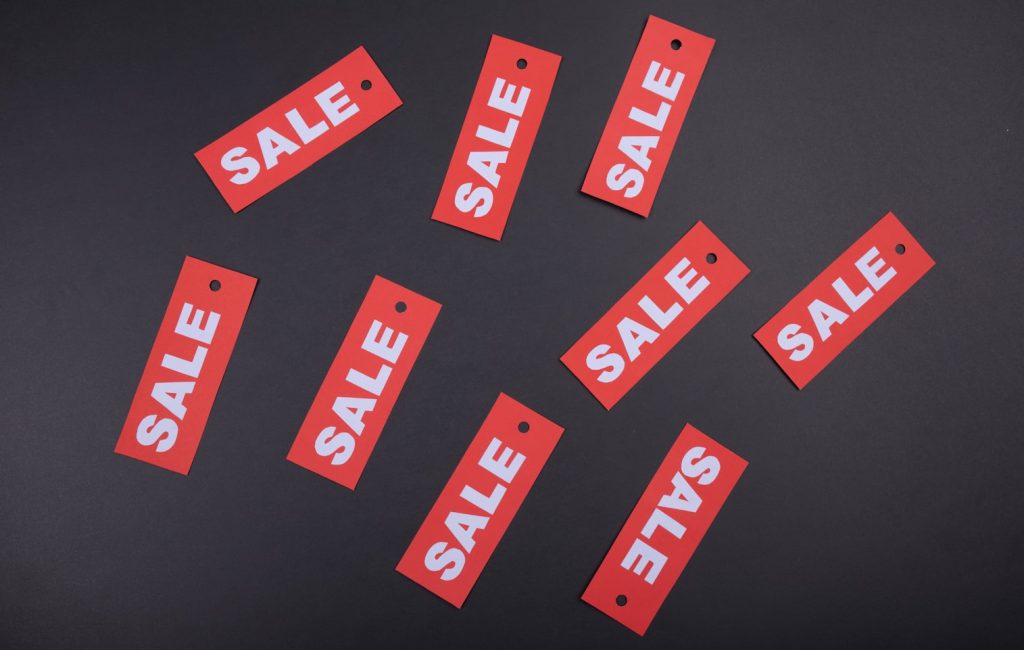 Rectangular red sale signs representing competitive pricing