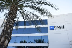 Exterior of Caris Life Sciences tissue lab with a coconut tree in front of the building