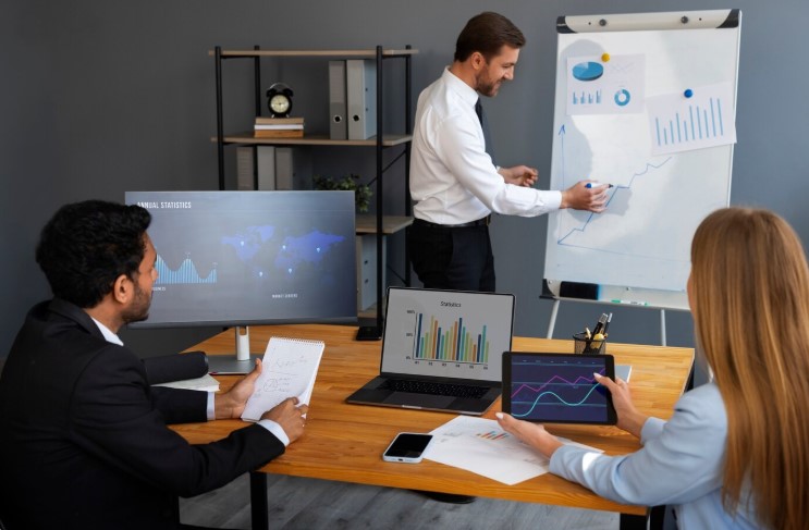 Business meeting discussing finance graphs, including debt-to-equity ratio