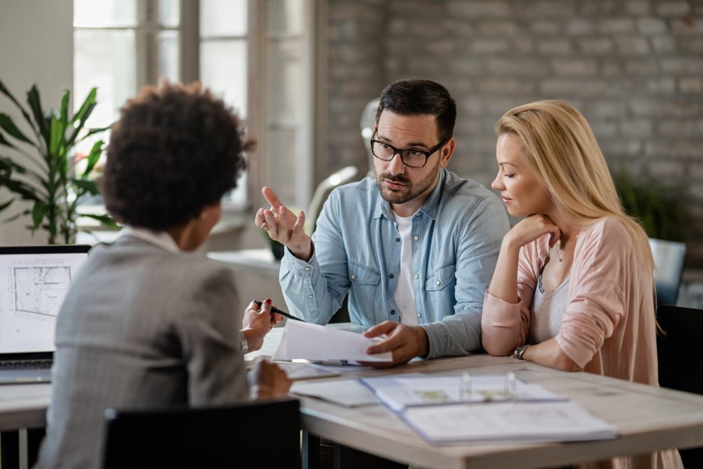 Couple discussing PenFed mortgage rates with a financial advisor