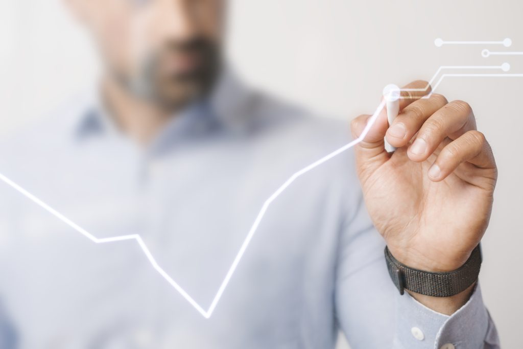 Man drawing investment graphs for Treynor ratio calculation