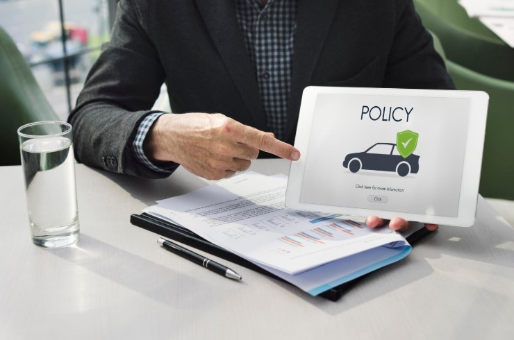 Insurance agent holding a visual presentation of market value insurance for car
