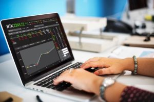 Person checking stock exchange to assess their required rate of return