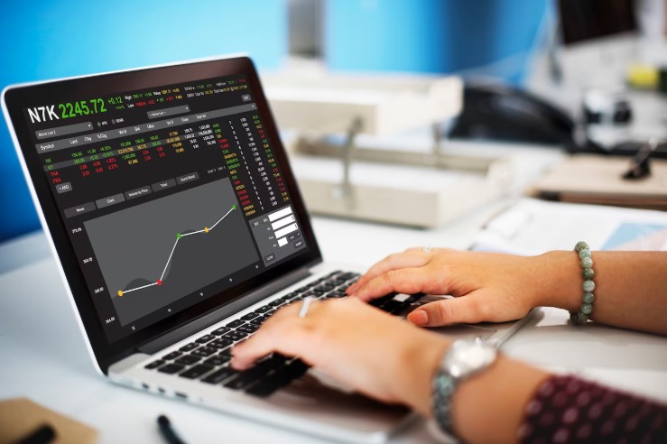 Person checking stock exchange to assess their required rate of return