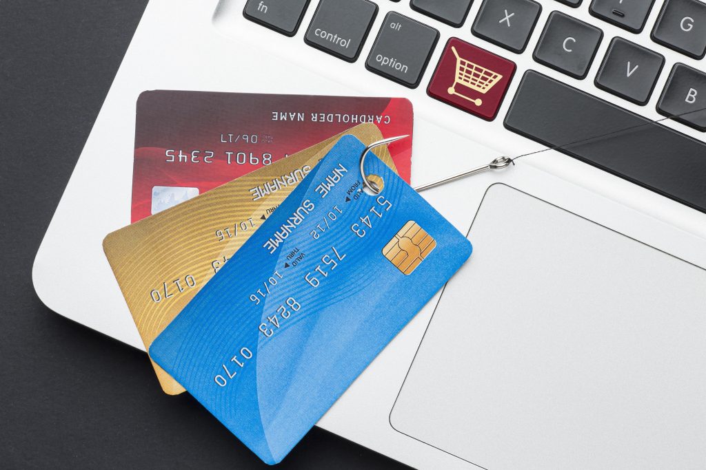 Top view of laptop with credit and debit cards, alternatives for ACH credit