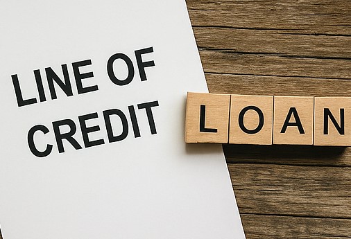 Line of credit on paper with wooden letters forming loan