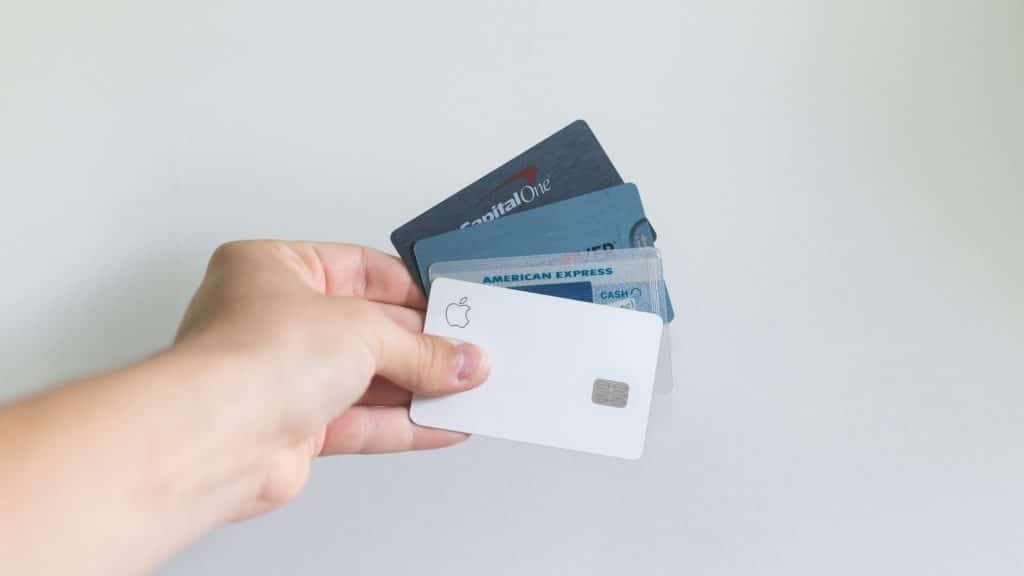 Hand holding charge card vs credit card