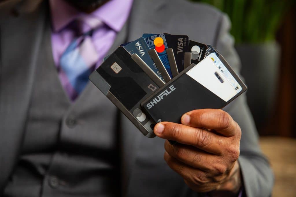 Person holding multiple charge cards vs credit card