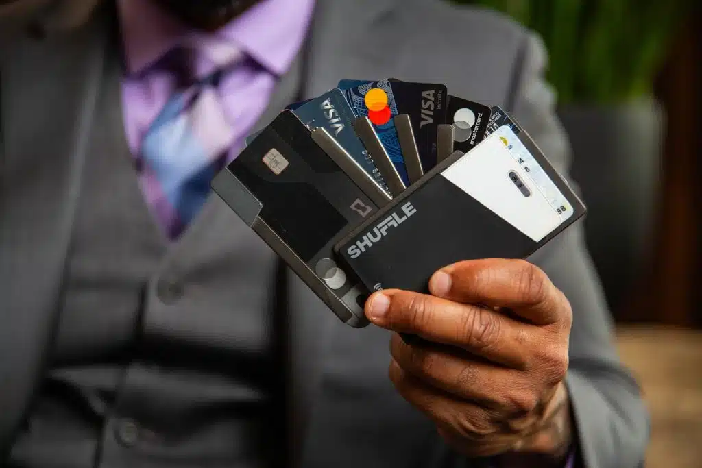Person holding multiple charge vs credit card