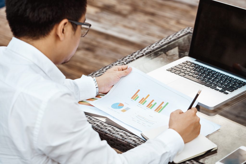 Business Concept - Young Business man woking on Financial plan. Strategy Analysis, EBITDA meaning