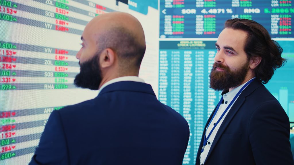 General manager and CEO sharing insight about a new development strategy with data on a big screen, presenting annual infographics to analyze business activity and proprietary trading status