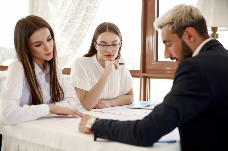 Two women consulting an estate attorney about Totten trust