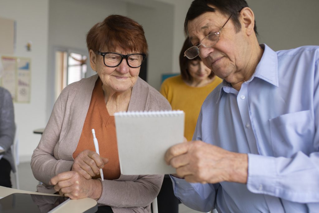 Older people looking at a notebook