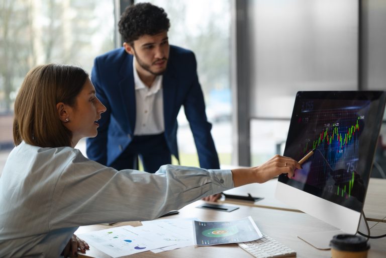 People in office analyzing three fund portfolio graph