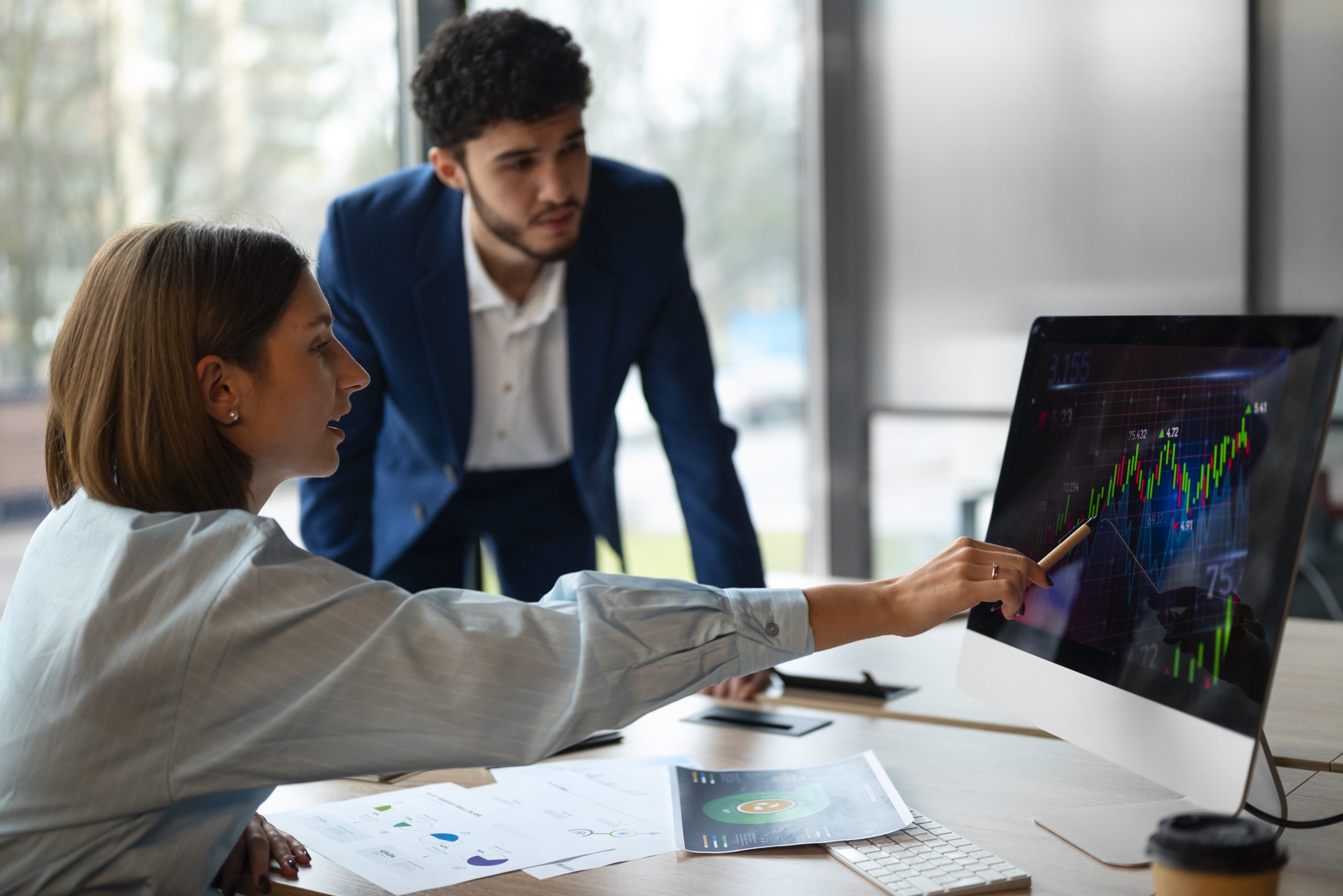 People in office analyzing three fund portfolio graph