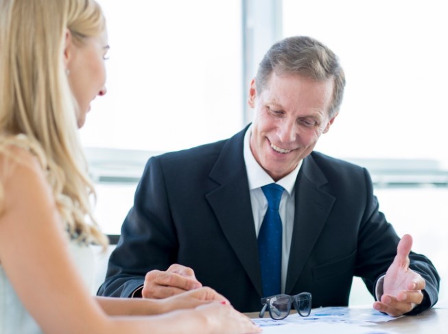 Blonde woman talking to an estate attorney about Totten trust