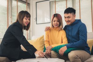 Happy young Asian couple and estate planner talking about credit shelter trust