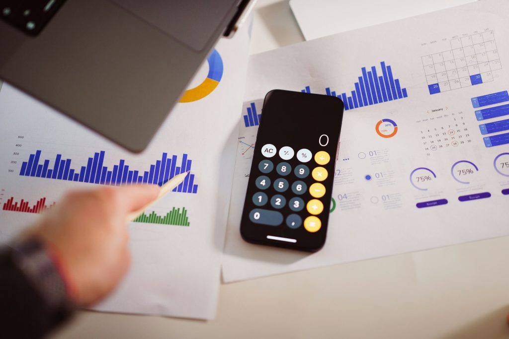 Calculator on top of papers with printed graphs and data