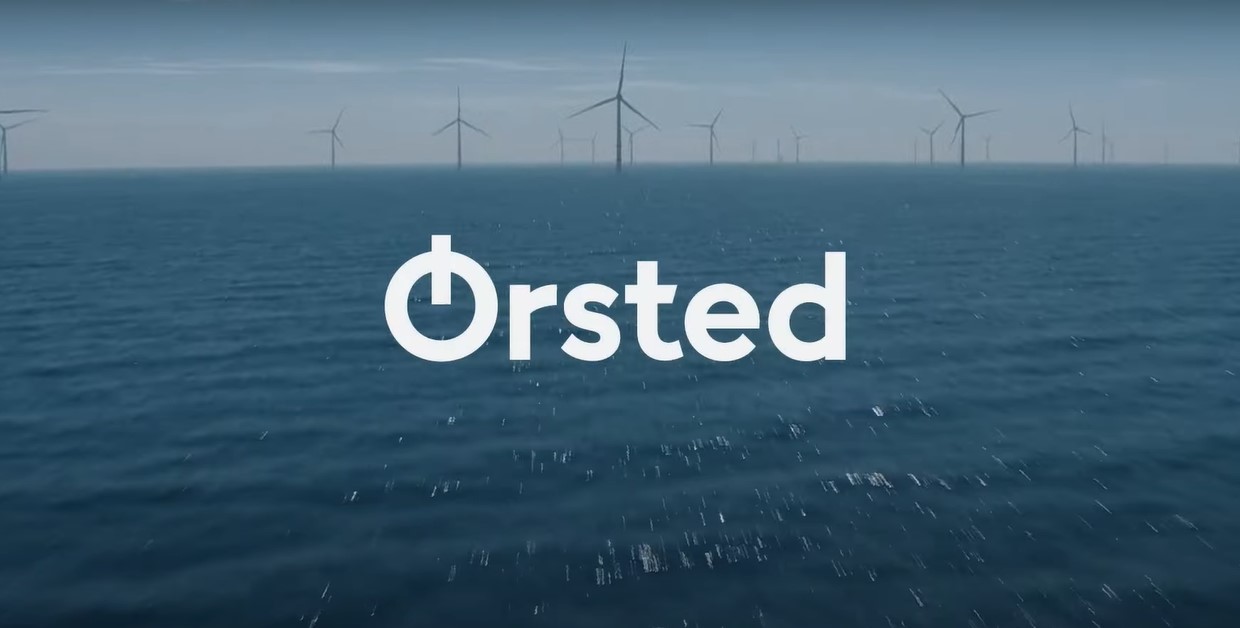 Orsted logo overlay on a full shot of offshore wind farm