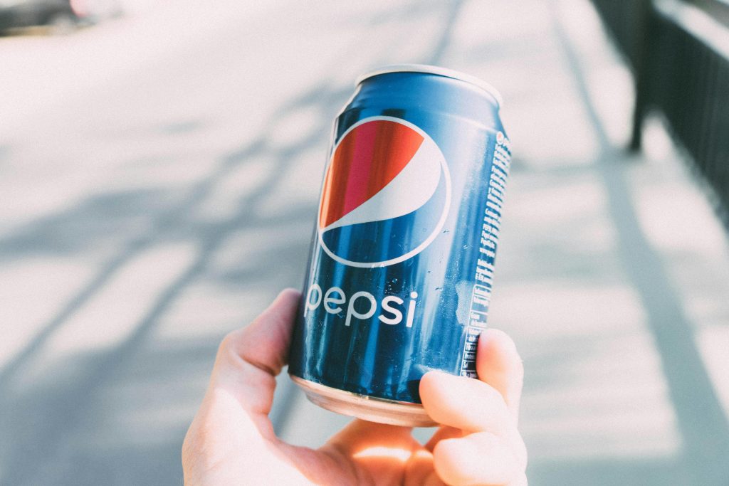 Close up shot of a hand holding a Pepsi can