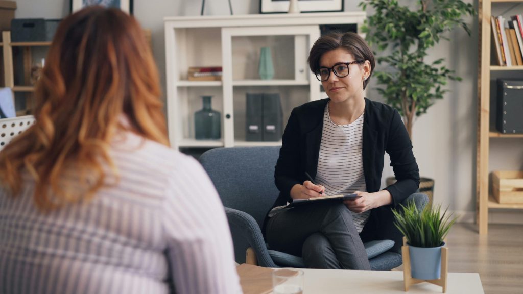 Medium close up of woman talking to an insurance agent
